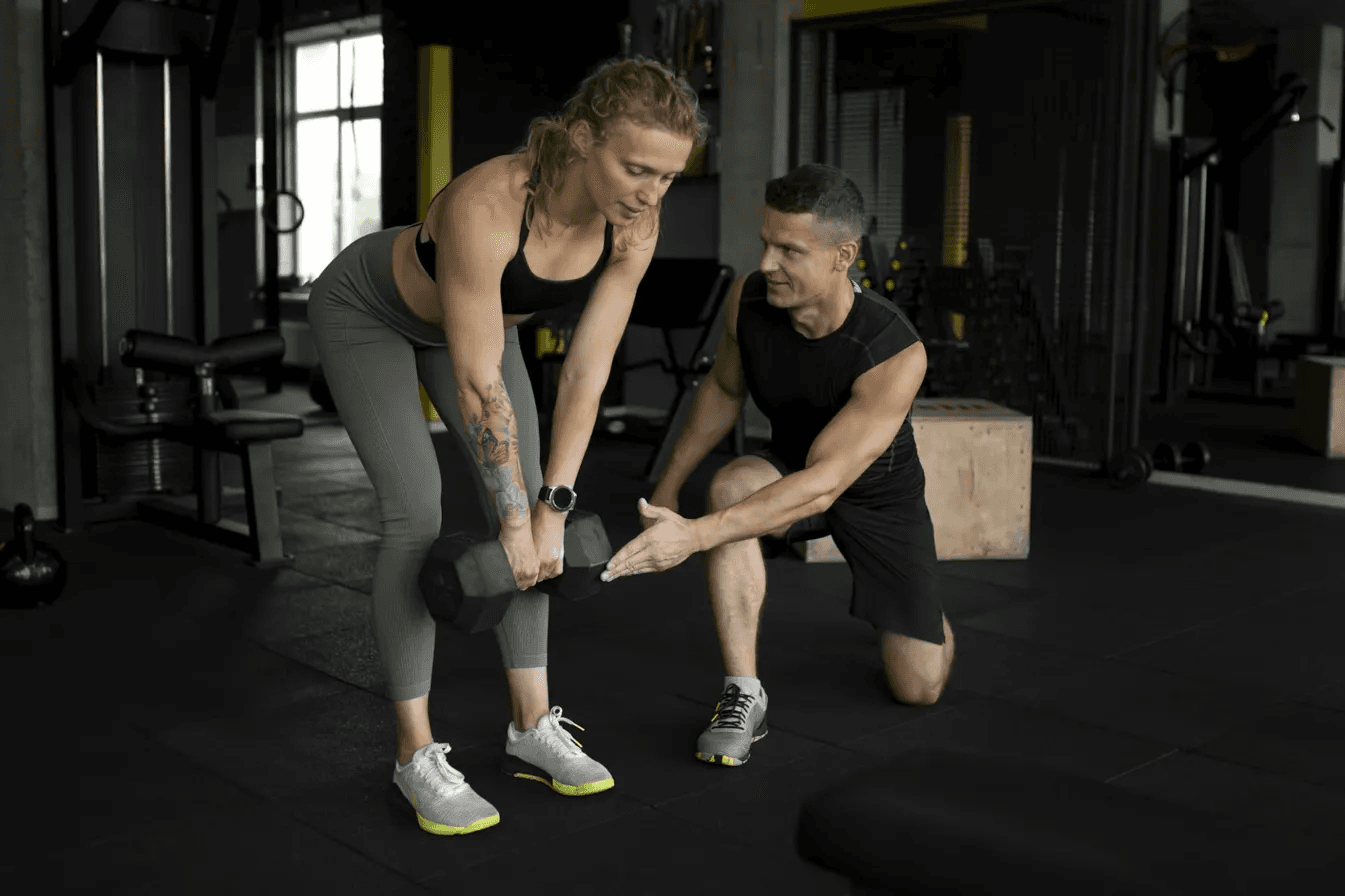 A physical therapist measures a patient's leg.